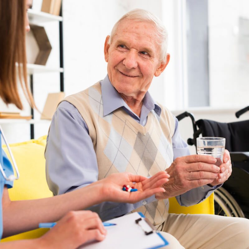nurse-giving-pills-smiley-old-man (2) (1)