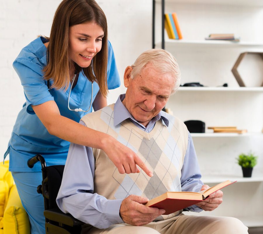 nurse-pointing-old-man-s-book (1)